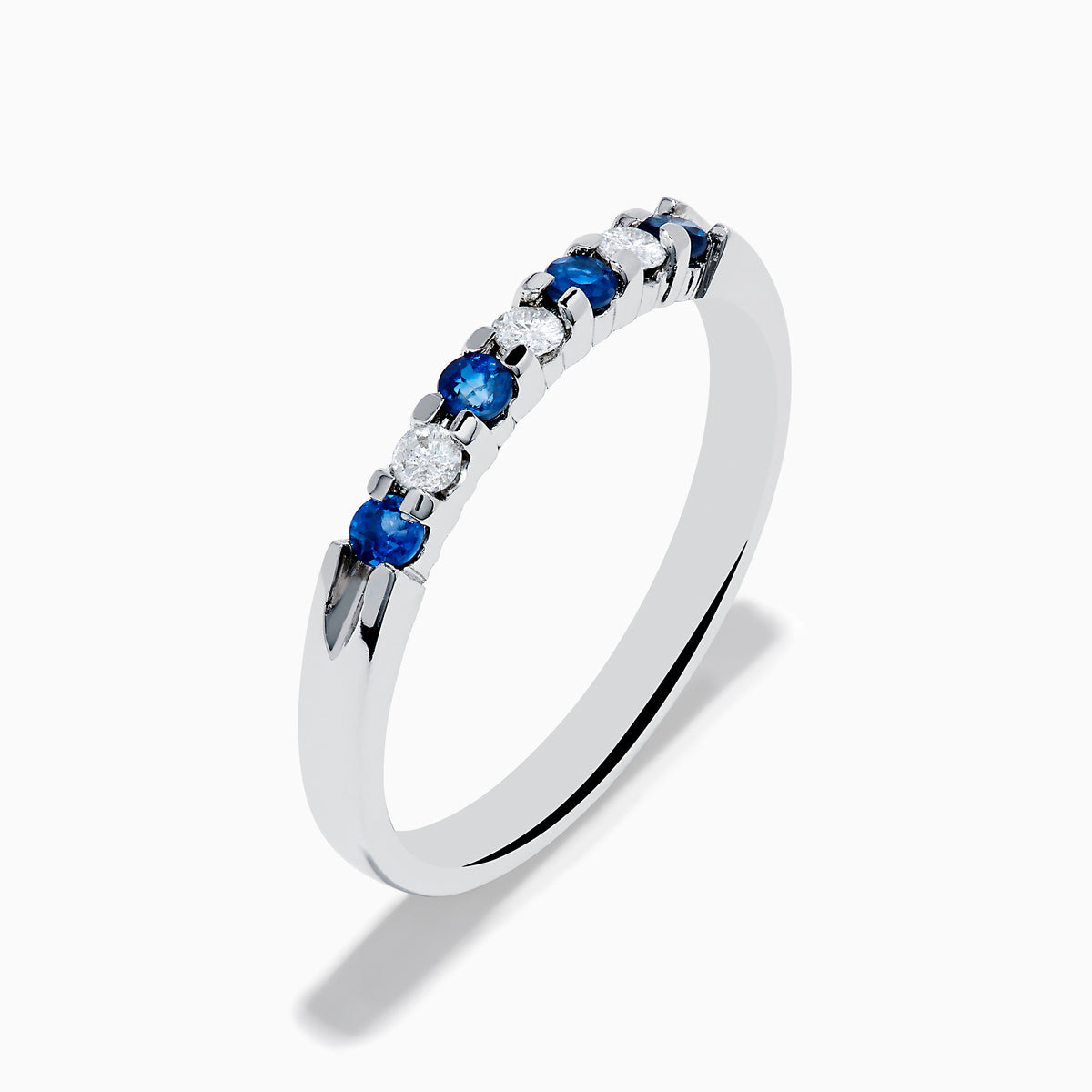 A 14K white gold band featuring alternating blue sapphires and diamonds (0.25 TCW), displayed against a white background.