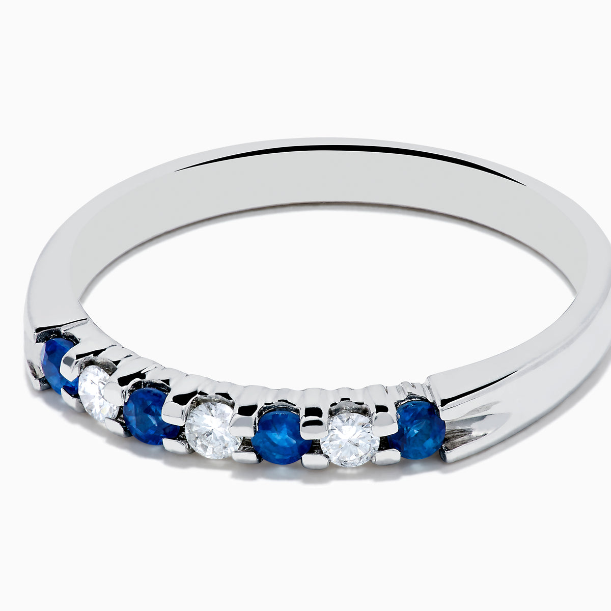A 14K white gold band featuring alternating blue sapphires and diamonds (0.25 TCW), displayed against a white background.