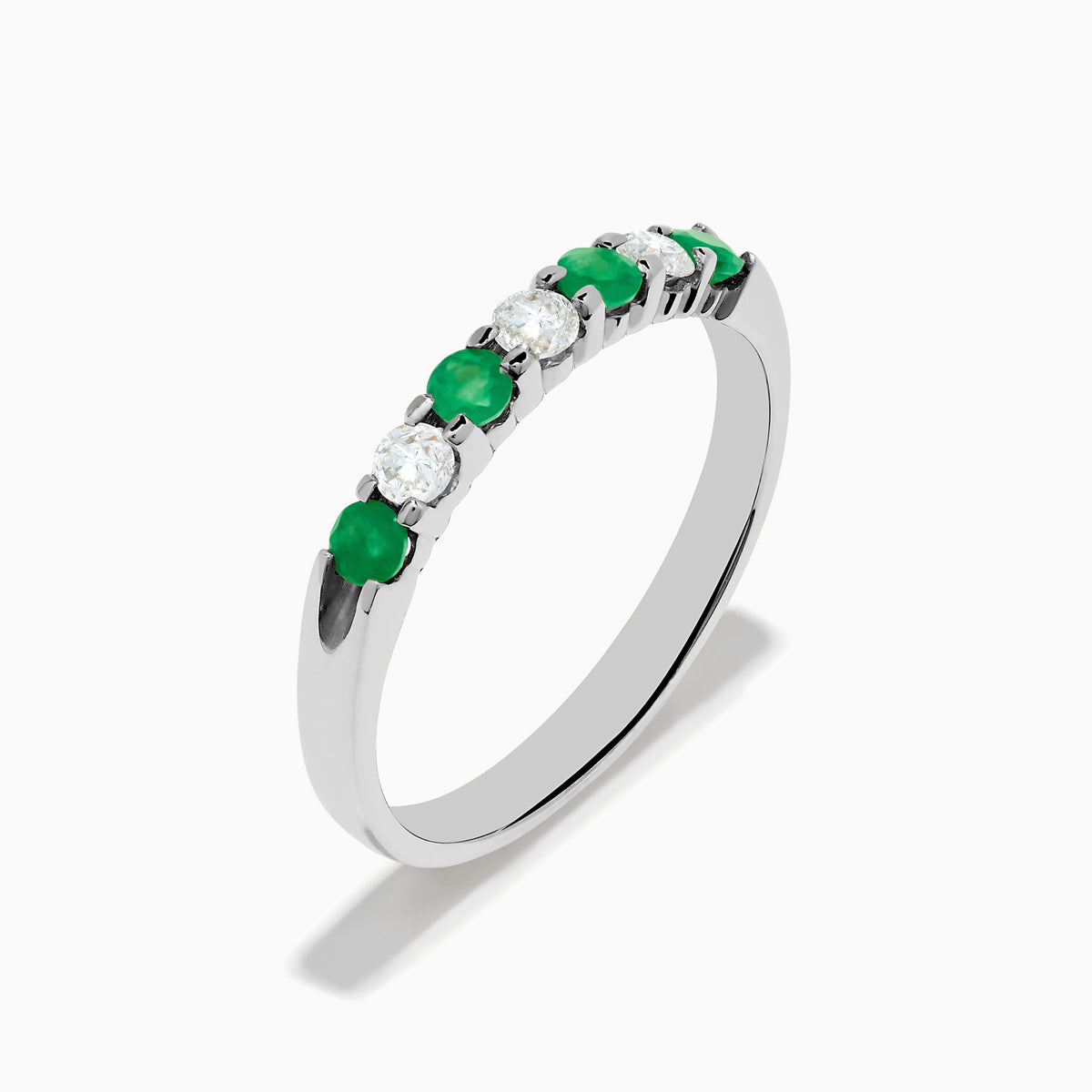 The 14K White Gold 7-Stone Emerald & Diamond Band, 0.50 TCW, showcases alternating round green emeralds and white diamonds on a plain white background.