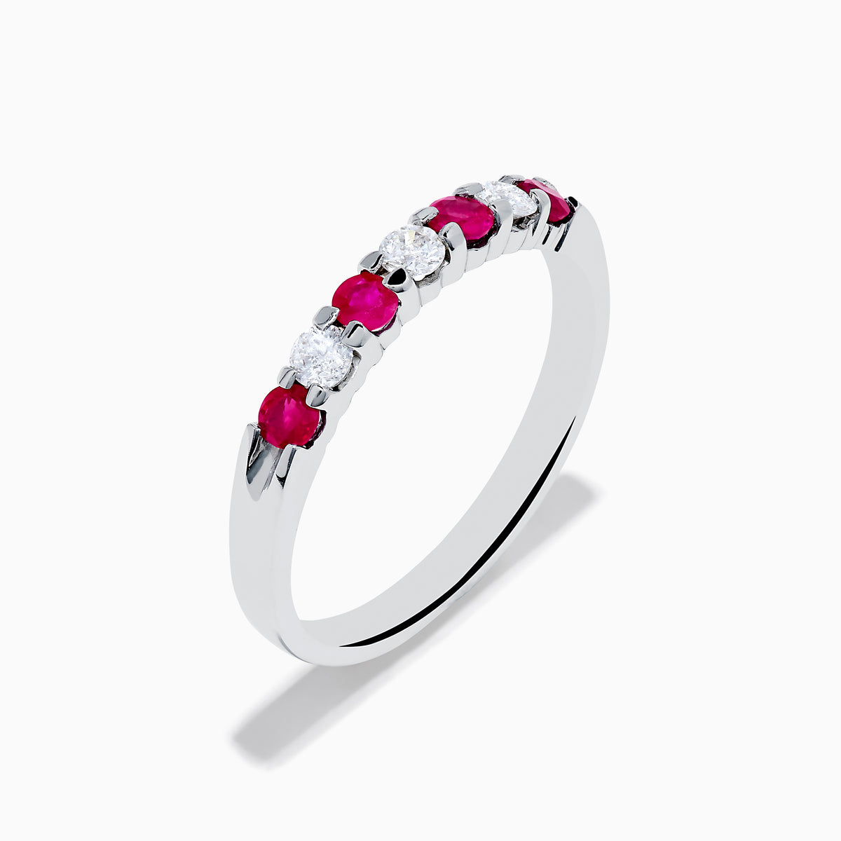 The 14K White Gold 7-Stone Ruby & Diamond Band, 0.50 TCW, showcases alternating round white diamonds and vibrant rubies on the front half of the band, set against a plain white background.