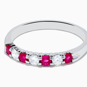 The 14K White Gold 7-Stone Ruby & Diamond Band, 0.50 TCW, showcases alternating round white diamonds and vibrant rubies on the front half of the band, set against a plain white background.