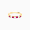The 14K Yellow Gold 7-Stone Ruby & Diamond Band, 0.50 TCW, features four round rubies and three round diamonds set alternately in a row on the band.