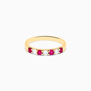 The 14K Yellow Gold 7-Stone Ruby & Diamond Band, 0.50 TCW, features four round rubies and three round diamonds set alternately in a row on the band.