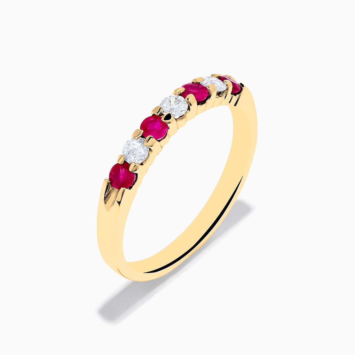 The 14K Yellow Gold 7-Stone Ruby & Diamond Band, 0.50 TCW, features four round rubies and three round diamonds set alternately in a row on the band.