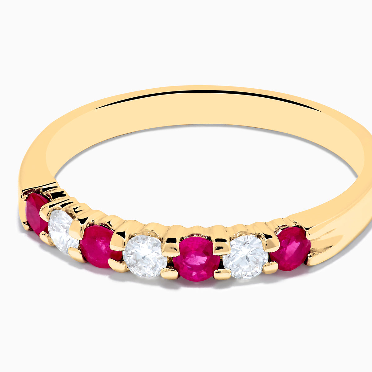 The 14K Yellow Gold 7-Stone Ruby & Diamond Band, 0.50 TCW, features four round rubies and three round diamonds set alternately in a row on the band.