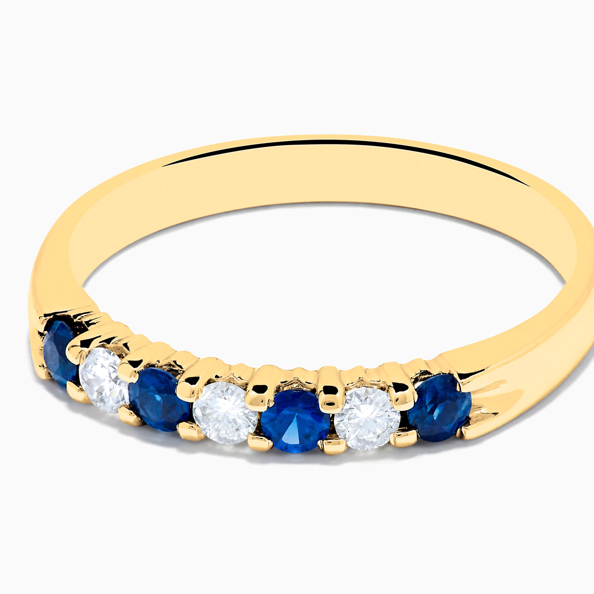 The 14K Yellow Gold 7-Stone Blue Sapphire & Diamond Band (0.50 TCW) features alternating sapphires and diamonds set in a row along the band, making it a striking accessory for any occasion. Displayed on a white background.