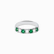 The 14K White Gold 7-Stone Emerald & Diamond Band (0.65 TCW) features alternating round emerald and diamond gemstones set in a row, displayed against a white background.