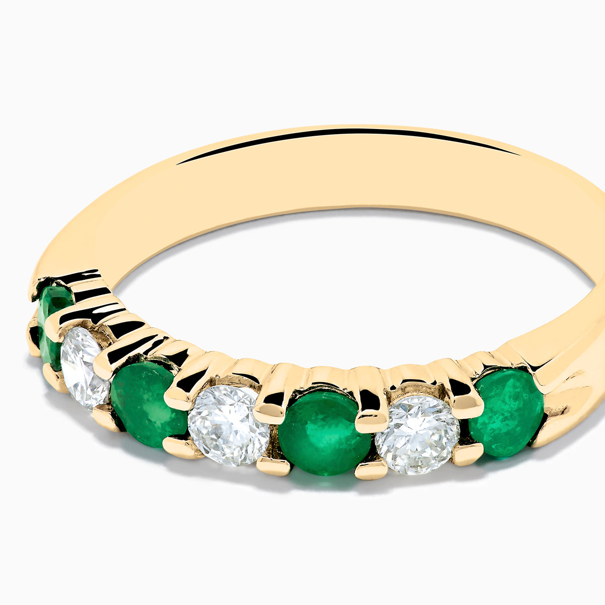 The 14K Yellow Gold 7-Stone Emerald & Diamond Band, 0.65 TCW, features alternating round green emeralds and white diamonds set in a row along the band, shown against a plain white background.
