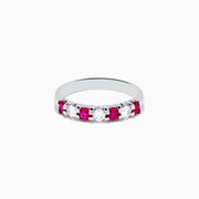 The 14K White Gold 7-Stone Ruby & Diamond Band, 0.65 TCW, features alternating round rubies and sparkling diamonds, showcased on a white background.