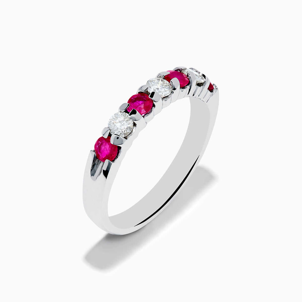 The 14K White Gold 7-Stone Ruby & Diamond Band, 0.65 TCW, features alternating round rubies and sparkling diamonds, showcased on a white background.