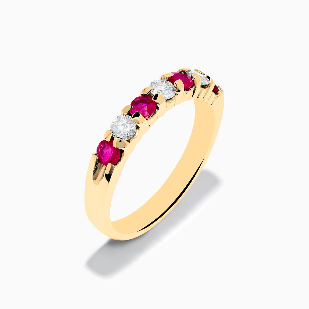 The 14K Yellow Gold 7-Stone Ruby & Diamond Band, 0.65 TCW, showcases alternating round rubies and diamonds set in a row along the band, displayed against a plain white background.