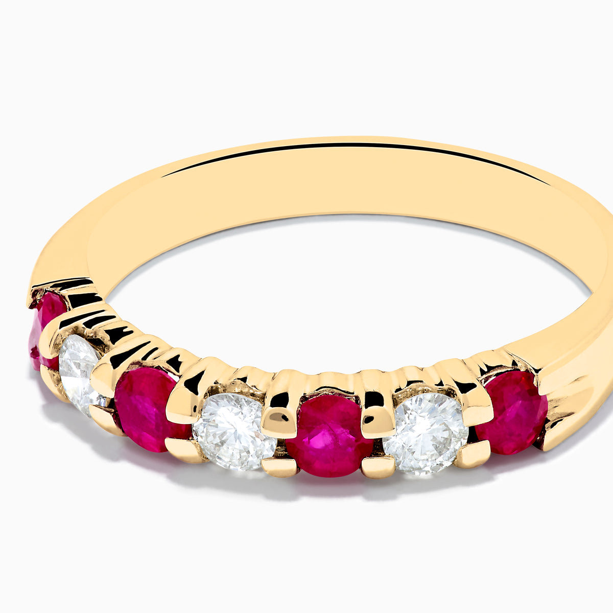 The 14K Yellow Gold 7-Stone Ruby & Diamond Band, 0.65 TCW, showcases alternating round rubies and diamonds set in a row along the band, displayed against a plain white background.