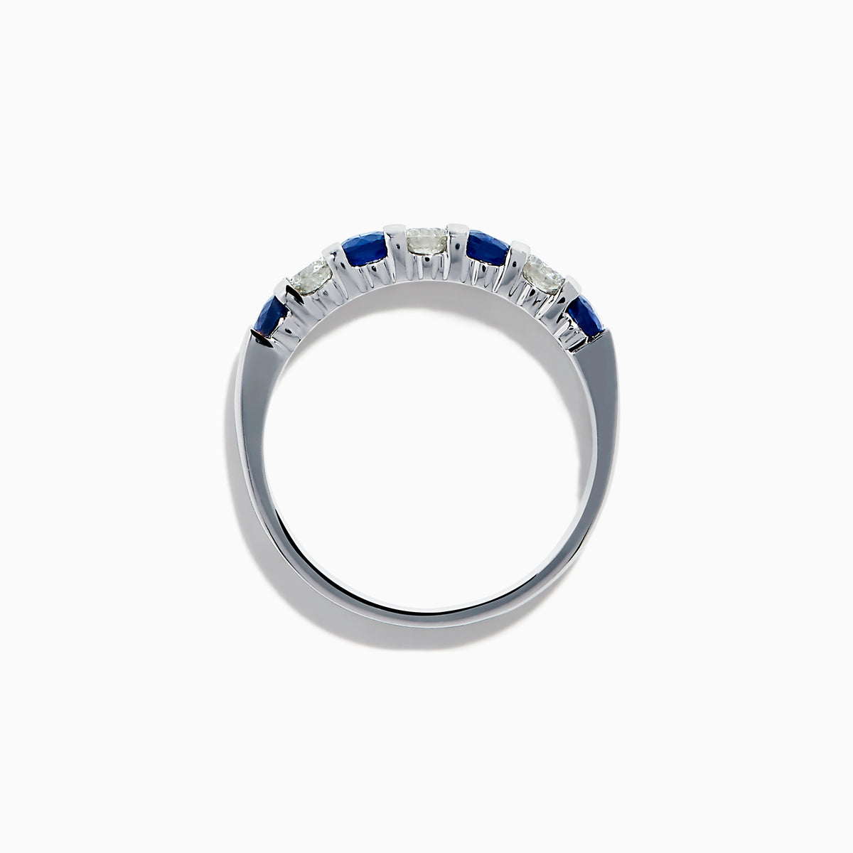 The 14K White Gold 7-Stone Blue Sapphire & Diamond Band, 0.65 TCW, features alternating round blue sapphires and sparkling white diamonds in a row on the band, shown against a white background.