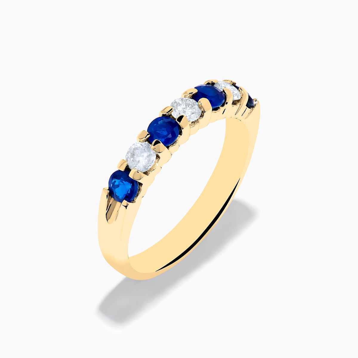 The 14K Yellow Gold 7-Stone Blue Sapphire & Diamond Band, 0.65 TCW, features alternating round blue sapphires and white diamonds set in a row along the band.