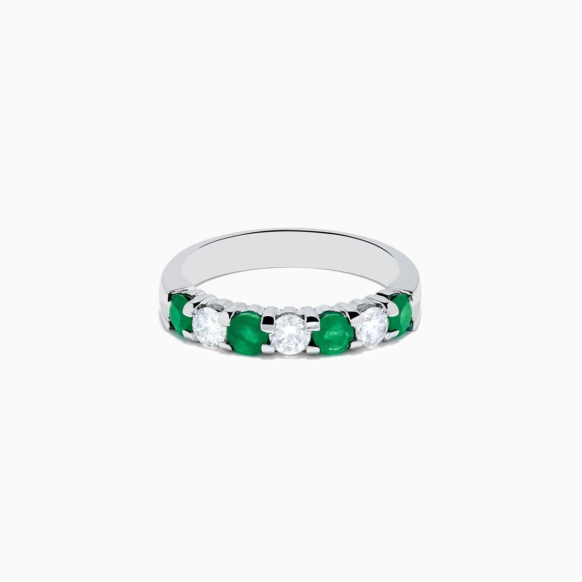 This 14K White Gold 7-Stone Emerald & Diamond Band, 1.00 TCW, features alternating round emeralds and sparkling white diamonds set in a sleek silver band.