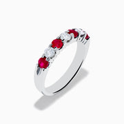 The 14K White Gold 7-Stone Ruby & Diamond Band, 1.00 TCW, showcases alternating round rubies and clear diamonds in a single row along the band, displayed on a white background.
