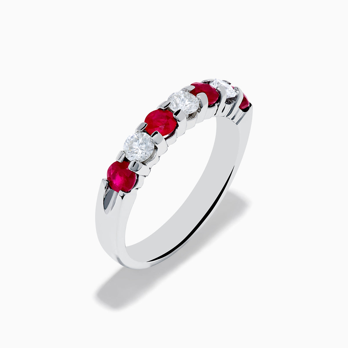 The 14K White Gold 7-Stone Ruby & Diamond Band, 1.00 TCW, showcases alternating round rubies and clear diamonds in a single row along the band, displayed on a white background.