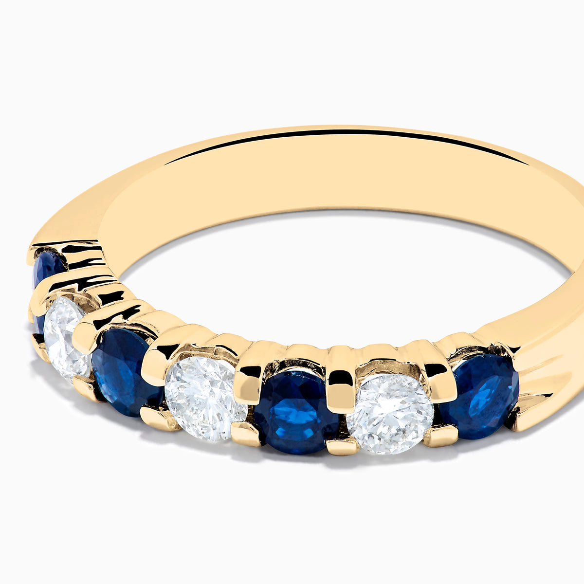 The 14K Yellow Gold 7-Stone Blue Sapphire & Diamond Band (1.00 TCW) features alternating blue sapphires and clear diamonds in a row along the gold band, shown on a white background.