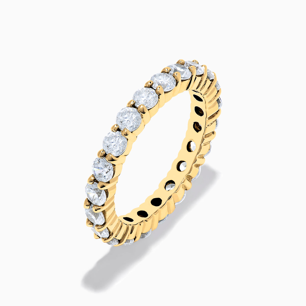 The 14K Yellow Gold Prong Set Diamond Eternity Band, 2.00 TCW, displays a seamless row of round white diamonds set in prongs on a plain white background.