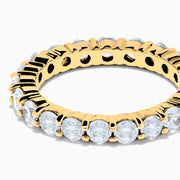 The 14K Yellow Gold Prong Set Diamond Eternity Band, 2.00 TCW, displays a seamless row of round white diamonds set in prongs on a plain white background.