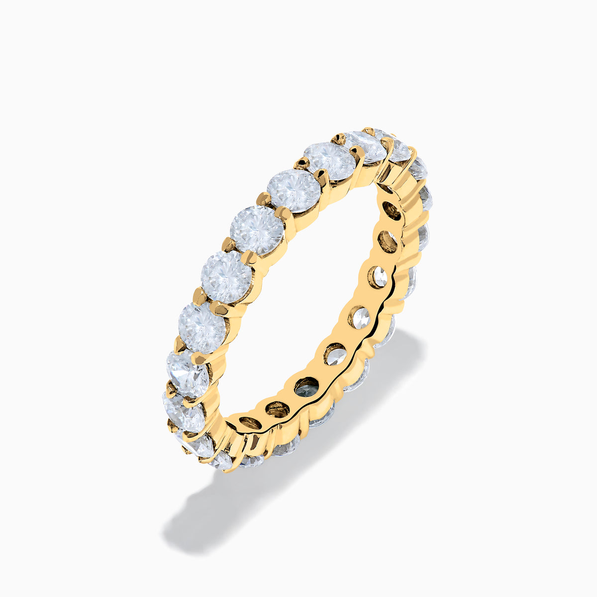 The 14K Yellow Gold Prong Set Diamond Eternity Band, 3.00 TCW, features round white diamonds encircling the entire ring and is shown against a plain white background.