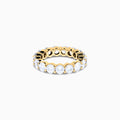 The 14K Yellow Gold Prong Set Diamond Eternity Band, 4.00 TCW, features round diamonds set all around and is shown against a plain white background.