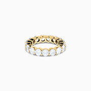 The 14K Yellow Gold Prong Set Diamond Eternity Band, 4.00 TCW, features round diamonds set all around and is shown against a plain white background.