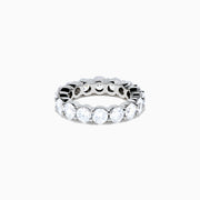 The 14K White Gold Prong Set Diamond Eternity Band, 5.00 TCW, features round diamonds encircling the band and is shown against a plain white background.
