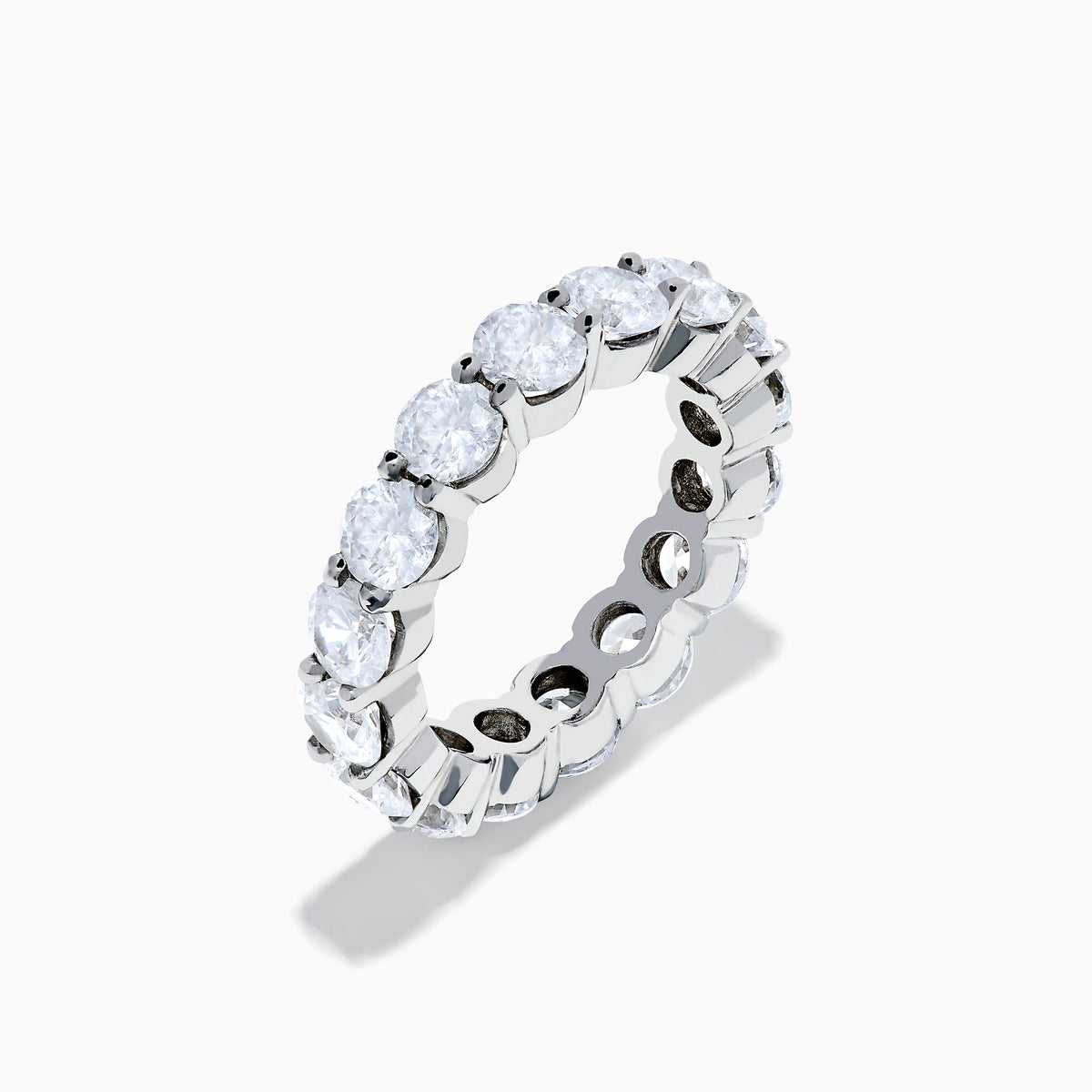 The 14K White Gold Prong Set Diamond Eternity Band, 5.00 TCW, features round diamonds encircling the band and is shown against a plain white background.