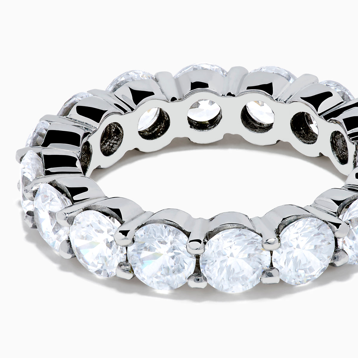 The 14K White Gold Prong Set Diamond Eternity Band, 5.00 TCW, features round diamonds encircling the band and is shown against a plain white background.