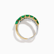 The 14K Two Tone Gold Emerald and Diamond Criss Cross Ring features intertwined yellow gold with green emeralds and white gold with clear round diamonds for a striking, modern look.
