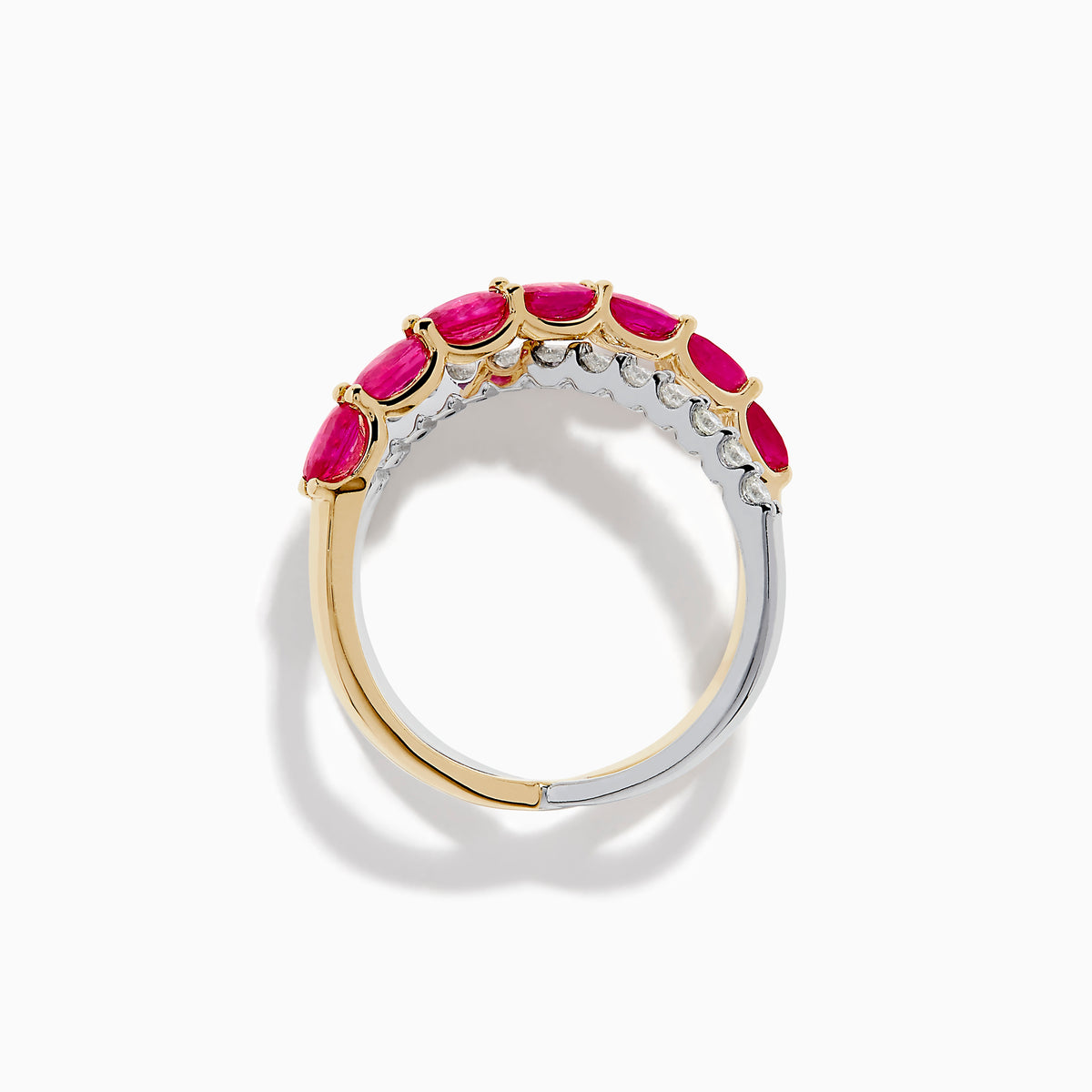The 14K Two Tone Gold Ruby and Diamond Criss Cross Ring features intersecting gold and silver bands—one set with round diamonds, the other with oval rubies—for a strikingly elegant look.