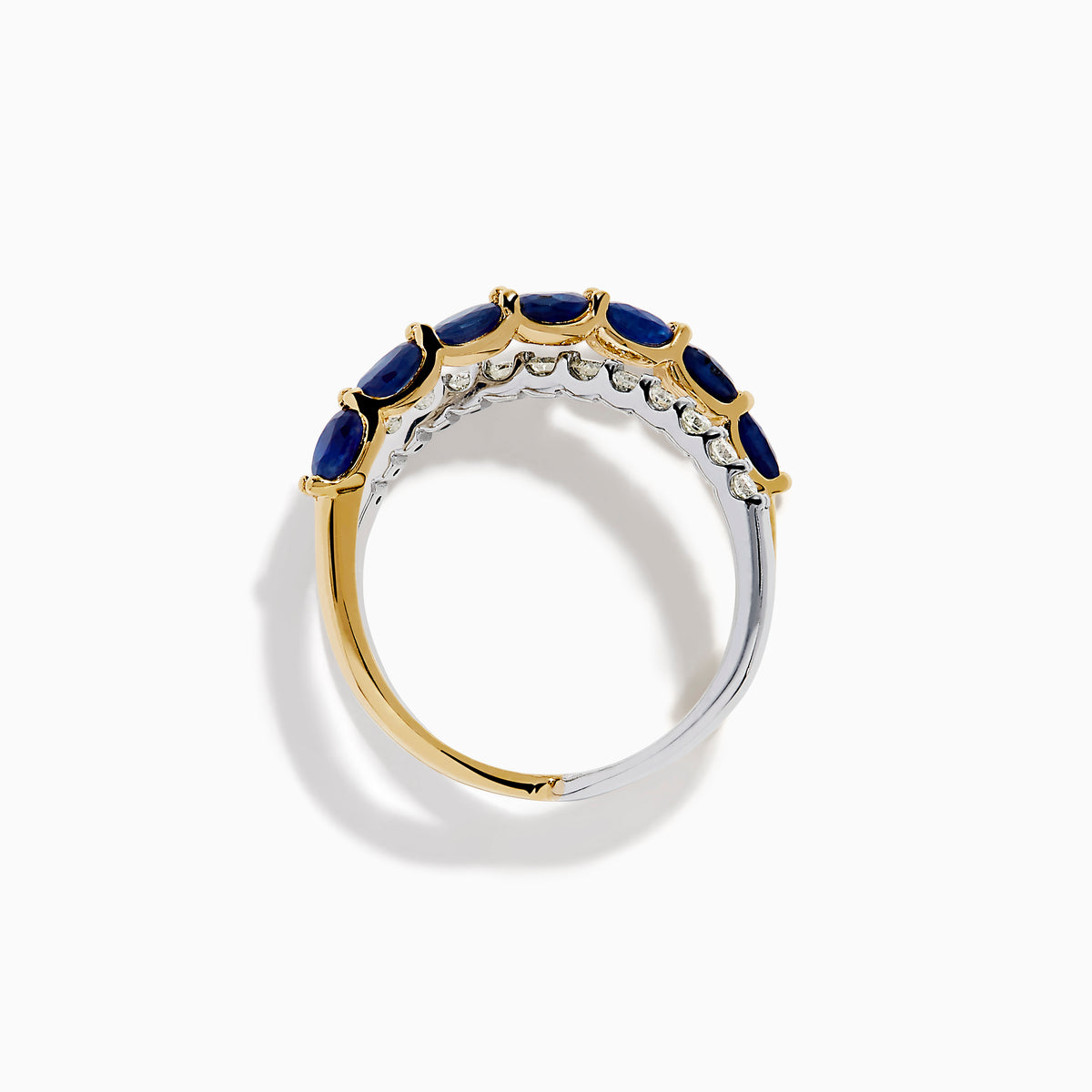 The Royale Bleu 14K Two Tone Gold Sapphire and Diamond Criss Cross Ring features alternating sapphires and clear diamonds, elegantly displayed against a white background.