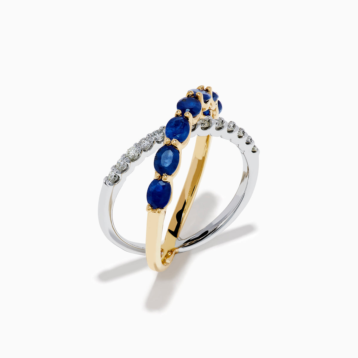The Royale Bleu 14K Two Tone Gold Sapphire and Diamond Criss Cross Ring features alternating sapphires and clear diamonds, elegantly displayed against a white background.