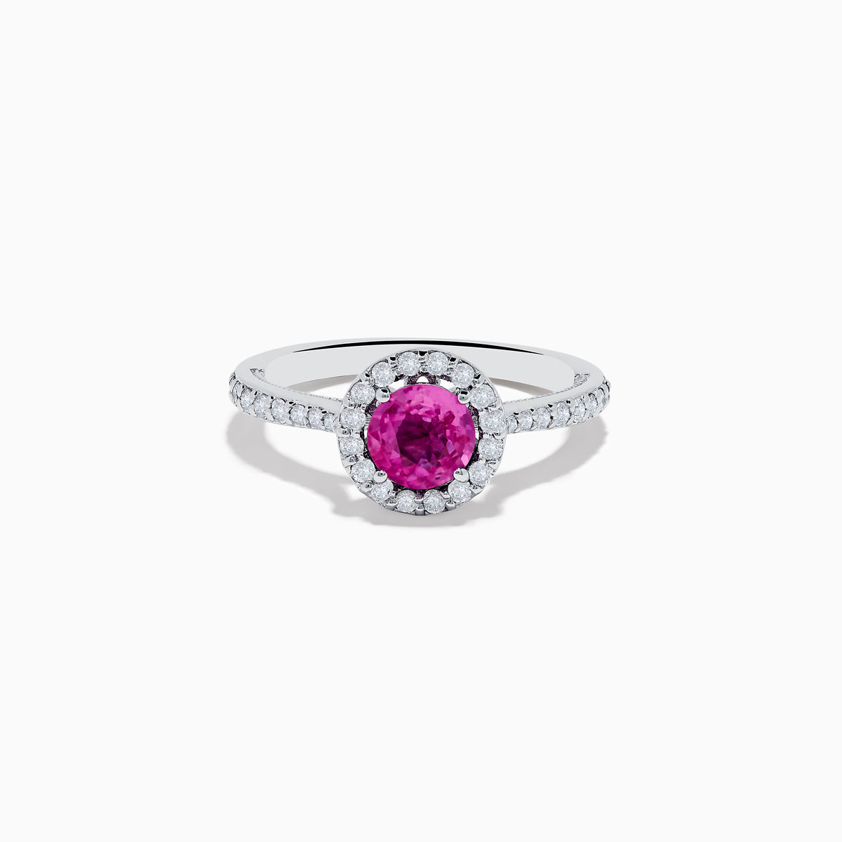 The 14K White Gold Pink Sapphire and Diamond Ring features a round pink sapphire center, a halo of diamonds, and additional diamonds along the band.