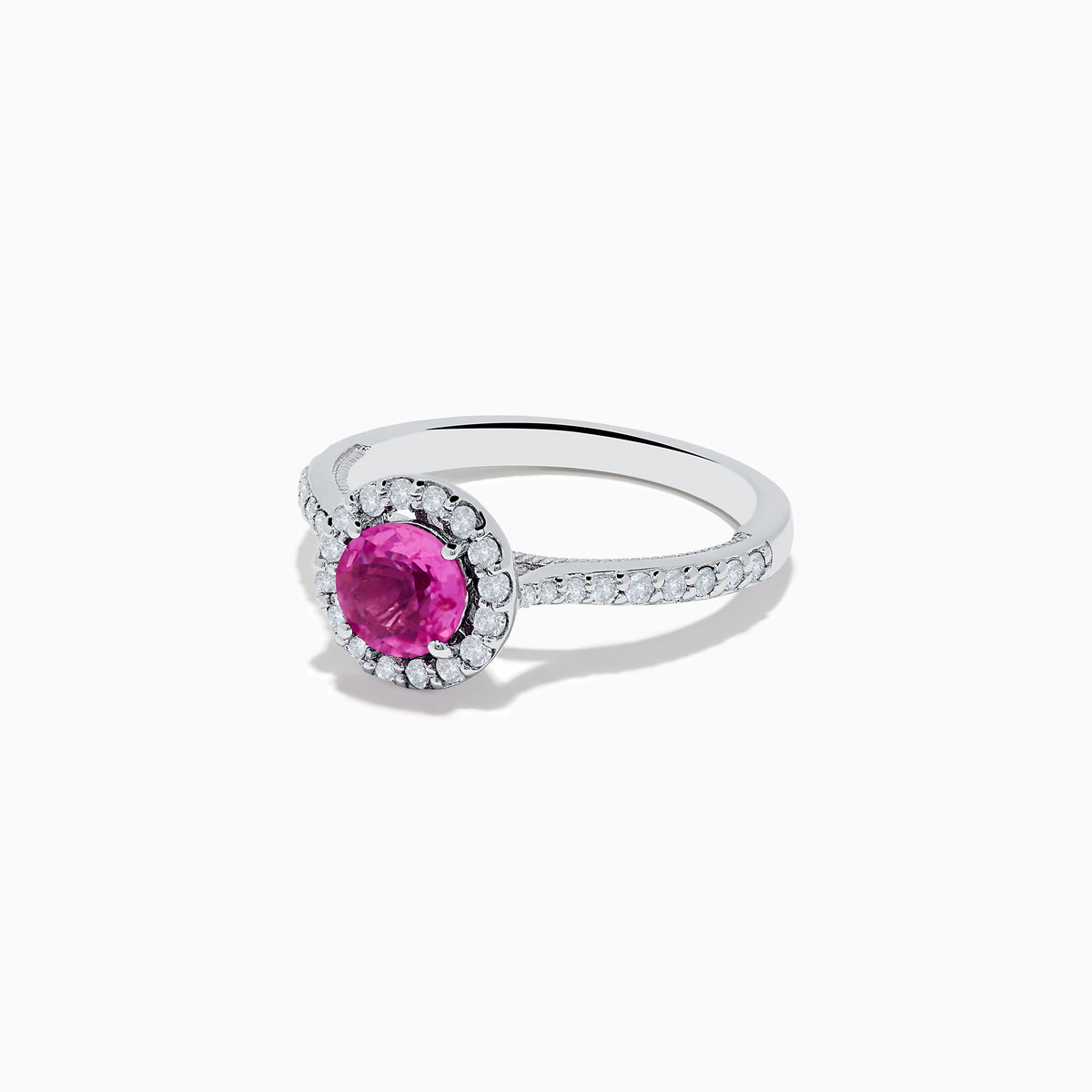 The 14K White Gold Pink Sapphire and Diamond Ring features a round pink sapphire center, a halo of diamonds, and additional diamonds along the band.