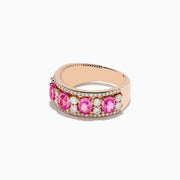 The 14K Rose Gold Pink Sapphire and Diamond Ring showcases a row of oval pink sapphires between two rows of small round white diamonds, set in rose gold and displayed against a white background.
