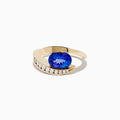 The Nahla Siri 14K Yellow Gold Tanzanite and Diamond Ring by Effy features a large oval tanzanite center stone, accented with a curved row of small round diamonds set along one side of the gold band.