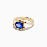 The Nahla Siri 14K Yellow Gold Tanzanite and Diamond Ring by Effy features a large oval tanzanite center stone, accented with a curved row of small round diamonds set along one side of the gold band.