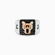 The Mens Signature 14K Two Tone Black Diamond and Emerald Panther Ring showcases a geometric gold panther head with green gemstone eyes set on a black, rectangular background adorned with black diamonds.