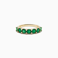 The 14K Yellow Gold Emerald and Diamond Band showcases oval green emeralds accented by small round white diamonds, beautifully displayed on a white background.