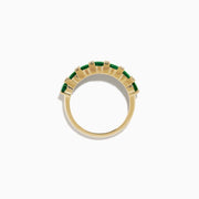 The 14K Yellow Gold Emerald and Diamond Band showcases oval green emeralds accented by small round white diamonds, beautifully displayed on a white background.