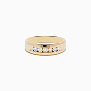 The Mens 14K Yellow Gold Diamond Channel Set Ring features a smooth band with eight round diamonds set in a straight row across the front, displayed against a plain white background.
