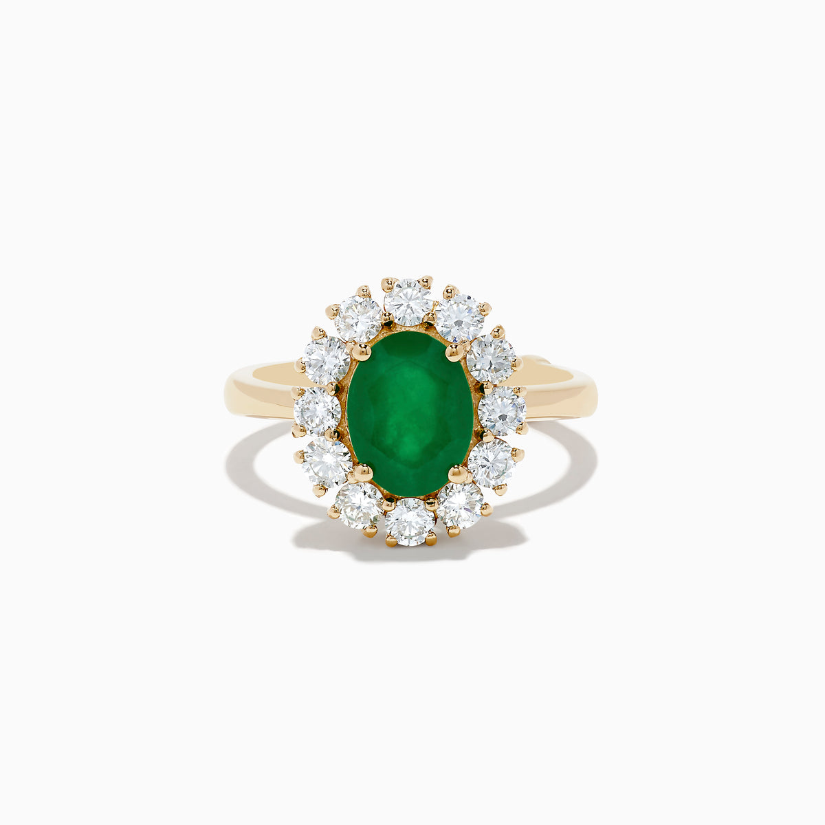 The 14K Yellow Gold Emerald and Diamond Ring showcases an oval emerald center accented by a halo of round white diamonds, displayed against a white background.