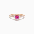 The Novelty 14K Rose Gold Pink Sapphire and Diamond Heart Ring showcases a heart-shaped pink sapphire center, a halo of white diamonds, and extra diamonds accenting the band.