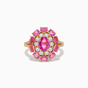 The 14K Yellow Gold Pink Sapphire and Diamond Ring features a large oval pink sapphire center, haloed by round diamonds and pink gemstones, with intricate band detailing.