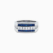 The Men's 14K White Gold Blue Sapphire and Diamond Channel Set Ring showcases a central row of round white diamonds bordered by two rows of square blue sapphires in a sleek, symmetrical design.
