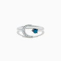 The Bella Bleu 14K White Gold White and Blue Diamond Crescent Moon Ring features a crescent moon with clear stones and an open band showcasing a round blue diamond opposite the moon.