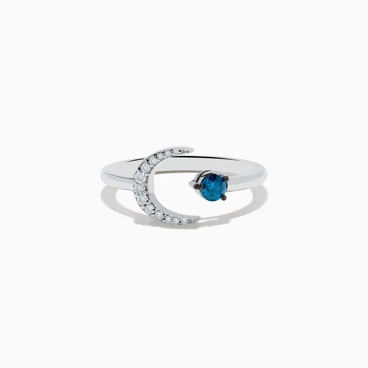 The Bella Bleu 14K White Gold White and Blue Diamond Crescent Moon Ring features a crescent moon with clear stones and an open band showcasing a round blue diamond opposite the moon.