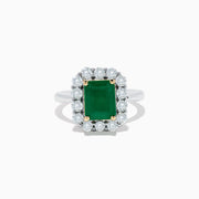 The Brasilica 14K Two-Tone Gold Emerald and Diamond Ring features a rectangular emerald, a halo of round diamonds, and silver band accented with gold prongs at each corner for a striking look.